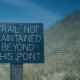 Operational Security Best Practices for Businesses - Go West IT Sign reads 'Trail not maintained beyond this point' against a blue, circuit-pattern background (warning that the trail ends).