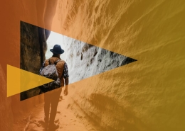 Hiker with backpack walking through a narrow canyon; orange geometric overlays emphasize adventure.